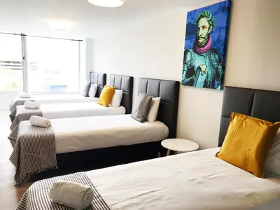 a room with three beds and a painting on the wall at Camões Lookout in Porto