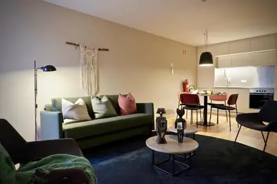 a living room with a green couch and a table at Oporto Serviced Apartments - Miragaia in Porto