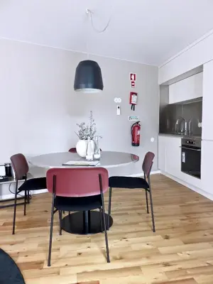 a kitchen and dining room with a table and chairs at Oporto Serviced Apartments - Miragaia in Porto