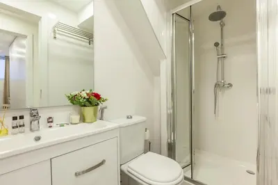 a white bathroom with a toilet and a shower at D&S - Torne Apartments in Vila Nova de Gaia