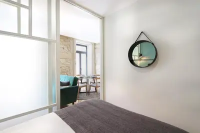 a bedroom with a bed and a mirror on the wall at HM - Pinheiro Downtown Living in Porto