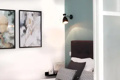 a room with three framed pictures on the wall at HM - Pinheiro Downtown Living in Porto