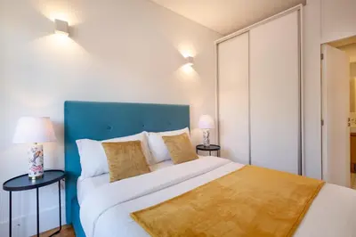 a bedroom with a large bed and two lamps at D&S - Porto São Bento Apartments III in Porto
