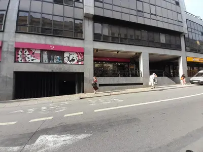 two people walking down a street in front of a building at VB Porto City Apartment by Flat in Porto in Porto