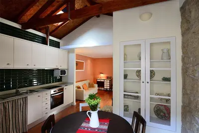 a kitchen and dining room with a table and chairs at Vitoria Apartments in Porto