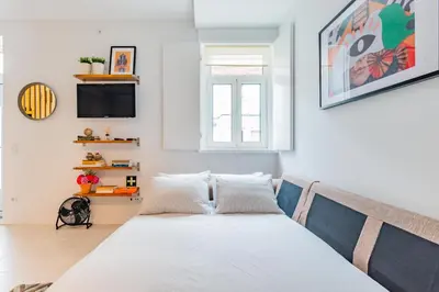 a bedroom with a bed and a tv at Design Boavista Music Home in Porto