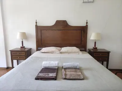 a bed with two towels on it with two night stands at DISCOVER PORTO - Boavista in Porto