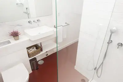 a white bathroom with a sink and a shower at Host Wise - Oporto Classic Apartment in Porto