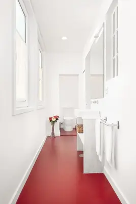 a bathroom with a red floor and a white sink at Host Wise - Oporto Classic Apartment in Porto