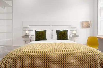 a bedroom with a large bed with a yellow blanket at Host Wise - Oporto Classic Apartment in Porto