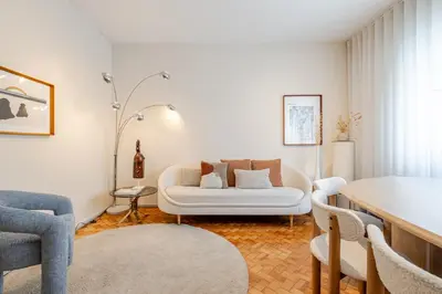 a living room with a white couch and chairs at UNIQUE Modernist Duplex apartment & PARKING in Porto