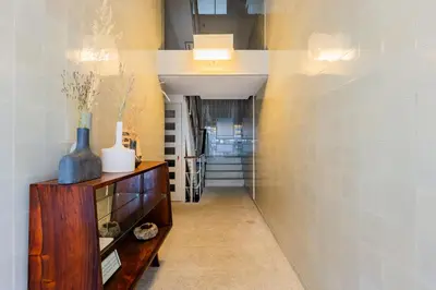 a hallway with a wooden cabinet with a vase on it at AMAZING DUPLEX - Mid Century Experience & PARKING in Porto