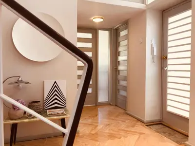 a hallway with a staircase with a table and a door at INCREDIBLE DUPLEX PENTHOUSE & TERRACES & Parking in Porto