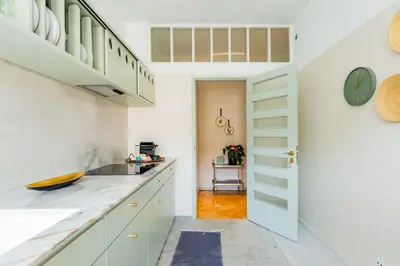 a kitchen with white cabinets and a sink at INCREDIBLE DUPLEX PENTHOUSE & TERRACES & Parking in Porto