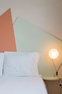 a white bed with a lamp next to it at INCREDIBLE DUPLEX PENTHOUSE & TERRACES & Parking in Porto