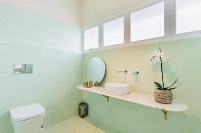 a bathroom with a sink and a mirror at INCREDIBLE DUPLEX PENTHOUSE & TERRACES & Parking in Porto