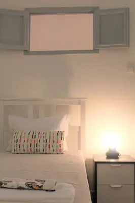 a bedroom with a bed and a lamp on a night stand at Pilar home in Vila Nova de Gaia