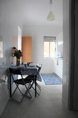 a kitchen with a table and chairs in a room at Pilar home in Vila Nova de Gaia