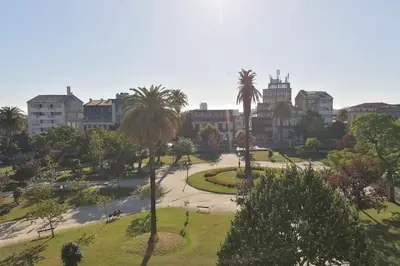 a park with palm trees in a city at Window Garden Apartment in Porto
