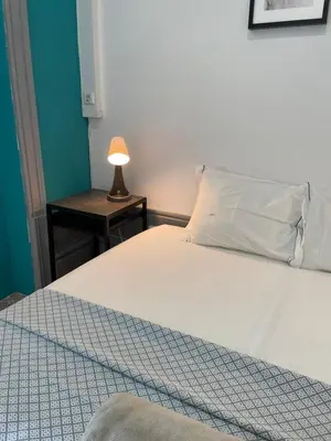 a room with a bunk bed and a rug at By Doors Hostel in Porto