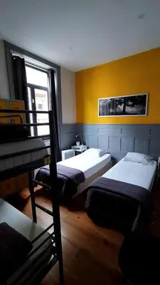 a bathroom with a white toilet and a sink at By Doors Hostel in Porto