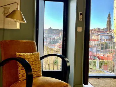 a living room with a couch and a table with a vase at Urban Apartment Casa da Portela in Porto