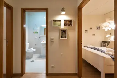 a bathroom with a bed and a toilet in a room at LovelyStay - The Porto Getaway w/ Free Parking in Porto