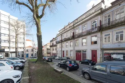 a city street with cars parked in front of buildings at LovelyStay - The Porto Getaway w/ Free Parking in Porto