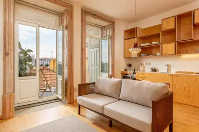 a living room with a couch and a kitchen at Tripas-Coração, Cordoaria River View, Garden View or Loft in Porto