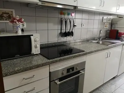 a kitchen with a microwave and a sink at Architect House in Porto