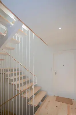 a staircase in a room with white walls and wooden floors at Liiiving in Porto - Charming Downtown Delight in Porto