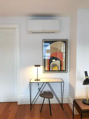a desk in a room with a painting and a stool at Oporto Chic&Cozy - Aliados in Porto