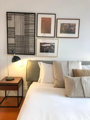 a bedroom with a large white bed and a table at Oporto Chic&Cozy - Aliados in Porto