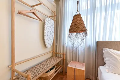 a kitchen with white cabinets and a wooden table at Sleep in Office in Porto