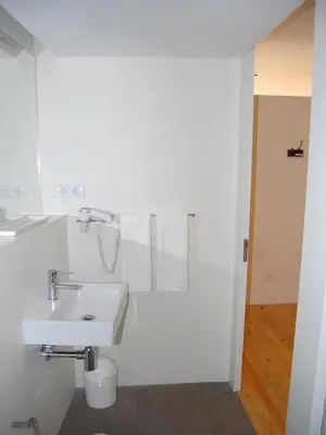 a white bathroom with a sink and a toilet at Top Flat in Porto