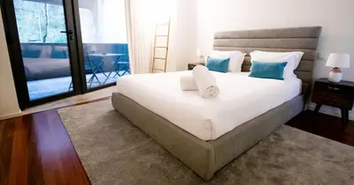 a room with a chair and a table and a bed at LUXURY VIEWS by YoursPorto in Vila Nova de Gaia