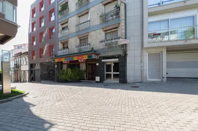an empty street in front of a building at QP Trindade Apartments in Porto