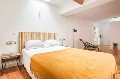 a bedroom with a large bed with a yellow blanket at Relax Porto Studio by Own Places in Porto