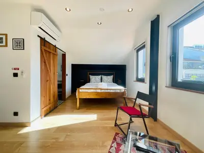 a bathroom with a sink and a mirror and a checkered floor at Boreal Porto Gaia - Patio & Pool in Vila Nova de Gaia