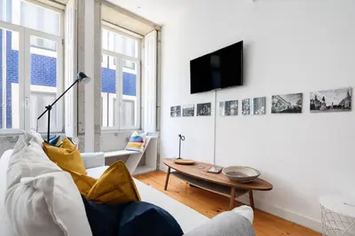 a living room with a couch and a table at Spacious Duplex in Porto's Downtown • A/C in Porto