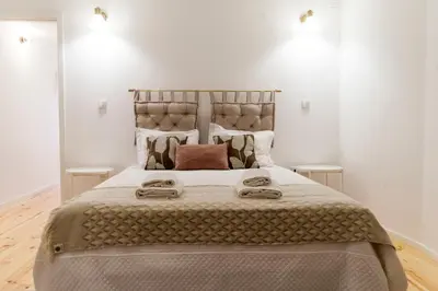 a bedroom with a large bed with two tables at Porto Historical Center Apartments in Porto
