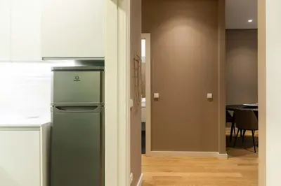 a kitchen with a refrigerator and a dining room at VIVA Size Flats Clérigos in Porto