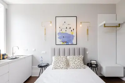 a white bedroom with a bed and a sink at Plaza-Charming GuestHouse in Porto