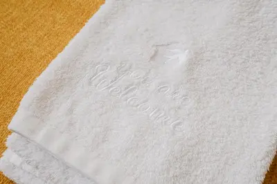 a white towel with the word order written on it at Plaza-Charming GuestHouse in Porto