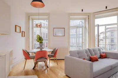 a living room with a couch and a table with chairs at BOUTIQUE Rentals-Kihara’s Ribeira Apt with great views in Porto