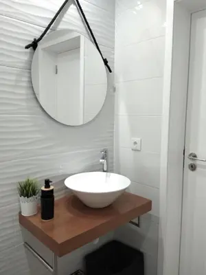 a bathroom with a white sink and a mirror at Chez Moi Bolhão in Porto