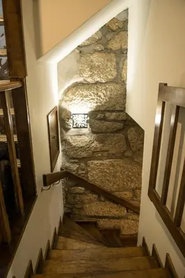 a stone staircase in a house with a stone wall at Vivenda Center Porto in Porto