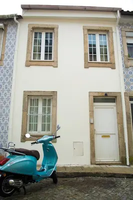 a blue scooter parked in front of a house at Vivenda Center Porto in Porto
