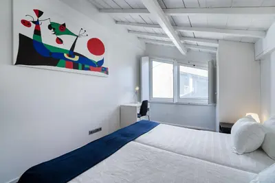 a bedroom with a large bed and a painting on the wall at Fine Arts Studios by Olala Homes in Porto