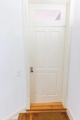 a white door in a room with a wooden floor at APOSENTUS - Your Home at Oliveiras in Porto